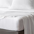bambaw cozy bamboo bed sheets close up on a bed with fitted sheets and pillows in white colour