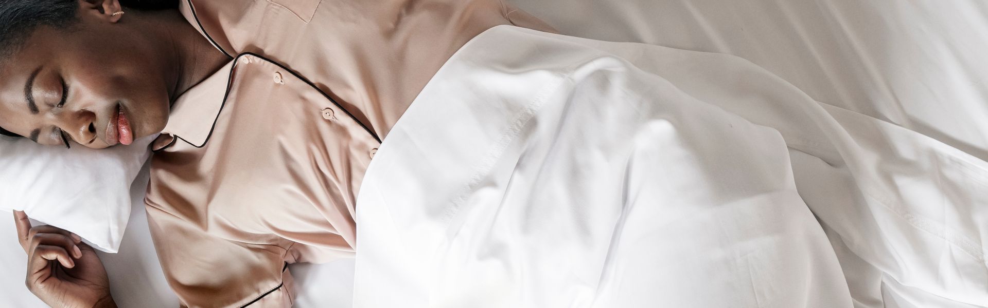Person sleeping in bed with Bambaw cozy bamboo white bedding