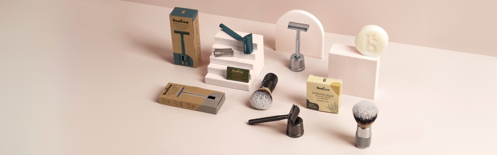 Collection of zerp waste shaving tools and accessories on a light pink background